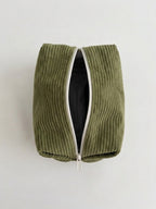 An olive green corduroy zippered pouch with a white zipper trim, shown open against a plain light gray background.